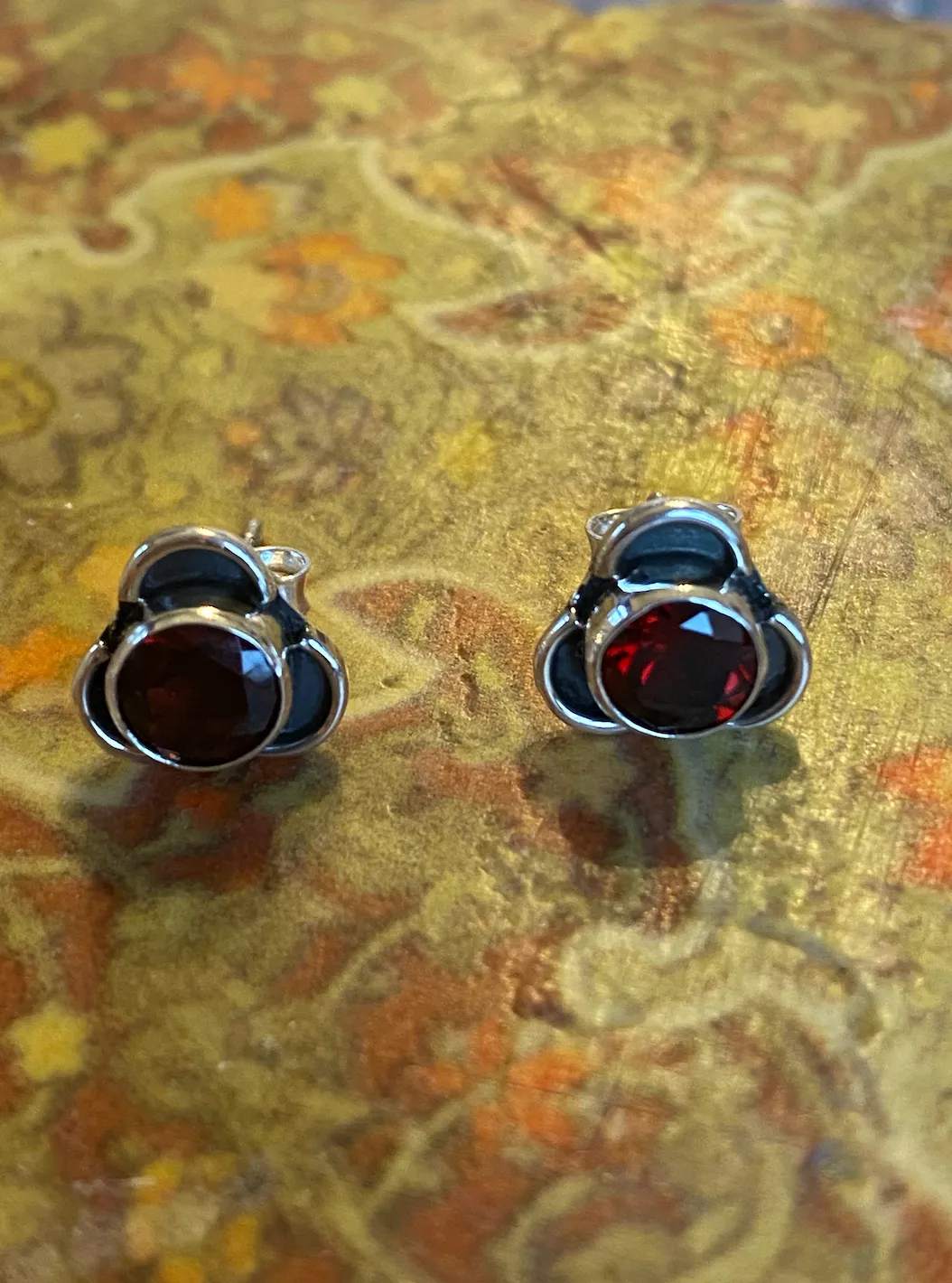 Solid Silver Garnet Stud Earrings with Triple Curve Frame