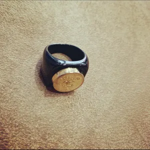 Vintage Chanel gold button ring in black setting