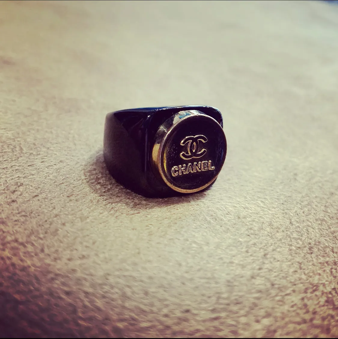 Vintage Chanel gold button ring in black setting
